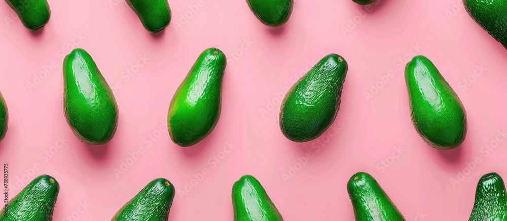 Green avocados arranged in a minimal flat lay style on a pink background, a pop art design representing a creative summer food concept. Top view banner image. Green avocados arranged in a minimal flat lay style on a pink background, a pop art design representing a creative summer food concept. Top view banner image.