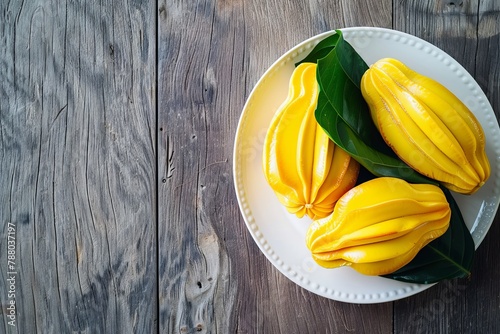 Fresh ripe jackfruit peeled and served on a white plate with a leaf straight from the tree