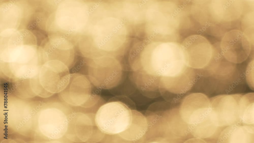 Abstract sea summer ocean sunset nature background. Small waves on golden water surface in motion blur with golden bokeh lights from sun. Holiday, vacation and recreation. Weather and climate change Abstract sea summer ocean sunset nature background. Small waves on golden water surface in motion blur with golden bokeh lights from sun. Holiday, vacation and recreation. Weather and climate change