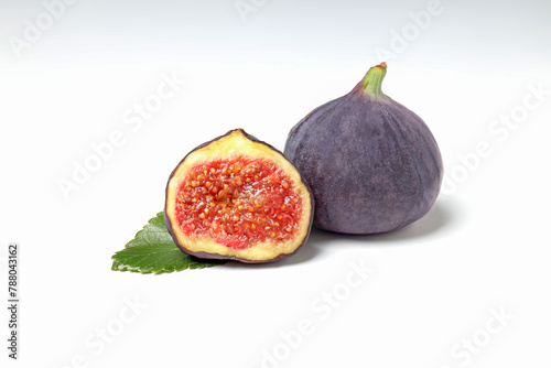 Fresh ripe figs with leaves on a white background