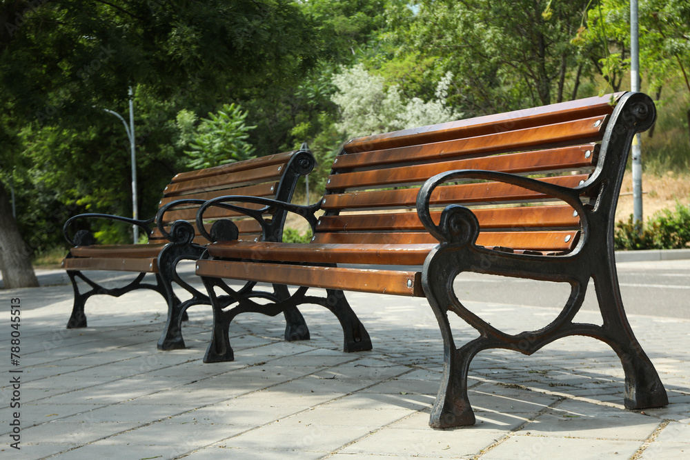 Beautiful wooden benches stand on the street Beautiful wooden benches stand on the street