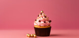 A scrumptious cupcake with pink frosting and a lavish assortment of chocolate and golden balls, set against a playful pink backdrop.