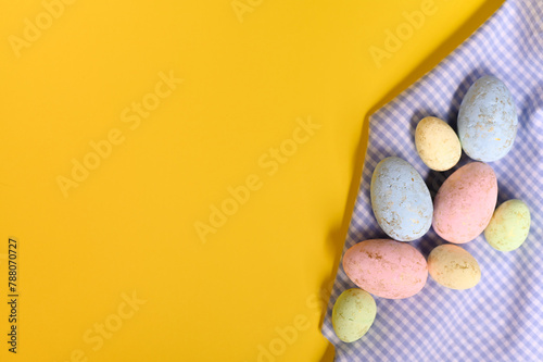 Easter background. Easter eggs on yellow.