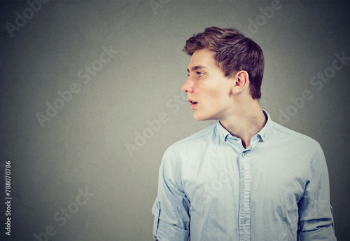 Portrait of a serious young man looking to the side 