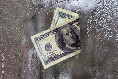 a dollar bill. stuck on the wet glass. the concept.