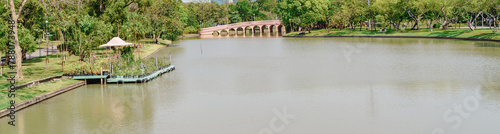 Panoramic View of a Peaceful Park with Pond. © InfinitePhoto