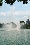 Spectacular Fountain Jet in Lake with Cityscape.