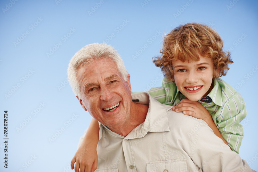 Happy, blue sky and portrait of grandfather and child piggy back for bonding, relationship and relax outdoors. Family, nature and grandpa with young boy on summer holiday, vacation or weekend at park