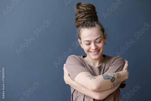 Canvas Print Candid portrait of smiling Caucasian woman with dreadlocks in bun hairstyle embr