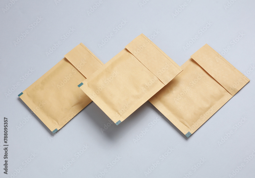 Shipping Post Parcel Envelopes Floating on Gray Background Shipping Post Parcel Envelopes Floating on Gray Background