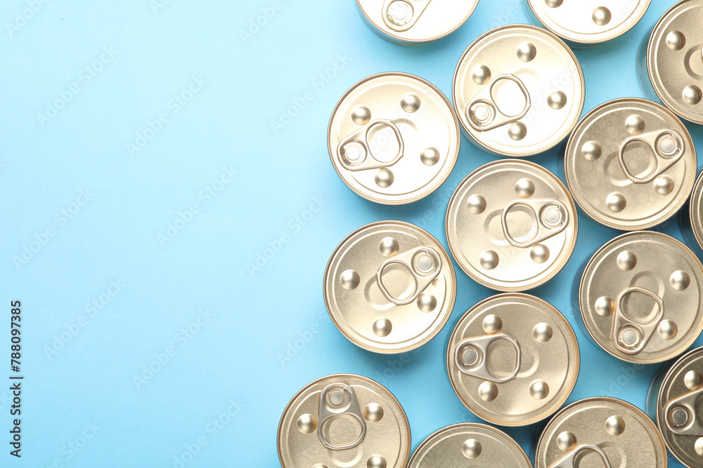 Cans with canned food on blue pastel background. Top view. Flat lay. Copy space Cans with canned food on blue pastel background. Top view. Flat lay. Copy space