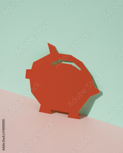 Red Paper-cut Piggy bank on blue-pink pastel background. Creative layout