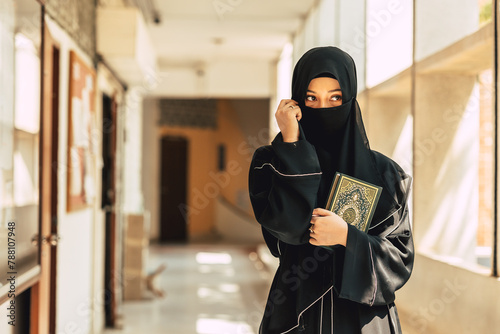Bild auf Leinwand Muslim niqab woman read and learning the Quran and faith The Holy Al Quran book