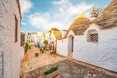 Trulli of Alberobello, Puglia, Italy. town of Alberobello with trulli houses among green plants and flowers photo