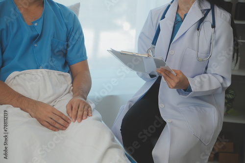 Young doctor is using a stethoscope listen to the heartbeat of the patient. Shot of a female doctor giving a male patient a check up