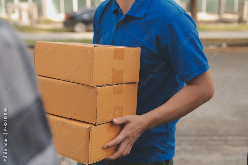 Asian delivery express courier young man use giving boxes to woman customer he wearing protective face mask at front home Asian delivery express courier young man use giving boxes to woman customer he wearing protective face mask at front home