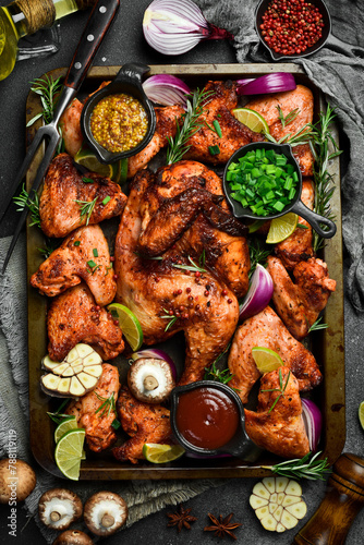 Grilled chicken on a metal tray. Barbecue. Traditional festive dish.