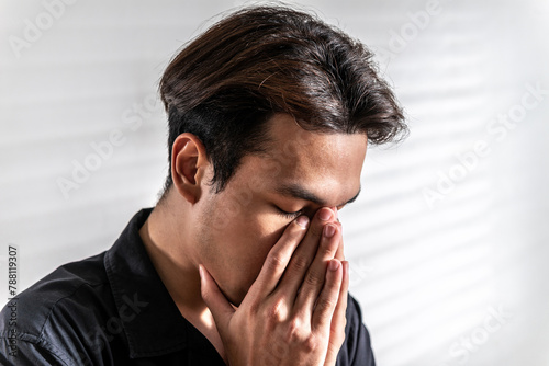 stress asian man nervous headache alone. loneliness frustration male person suffering from isolated tired pressure indoors. lonely attractive mental people depressed pain sad grief with difficulty