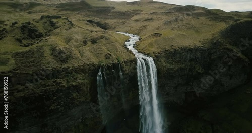 aerial view to the mountains river flows through the valley and falls down waterfal 4K  photo