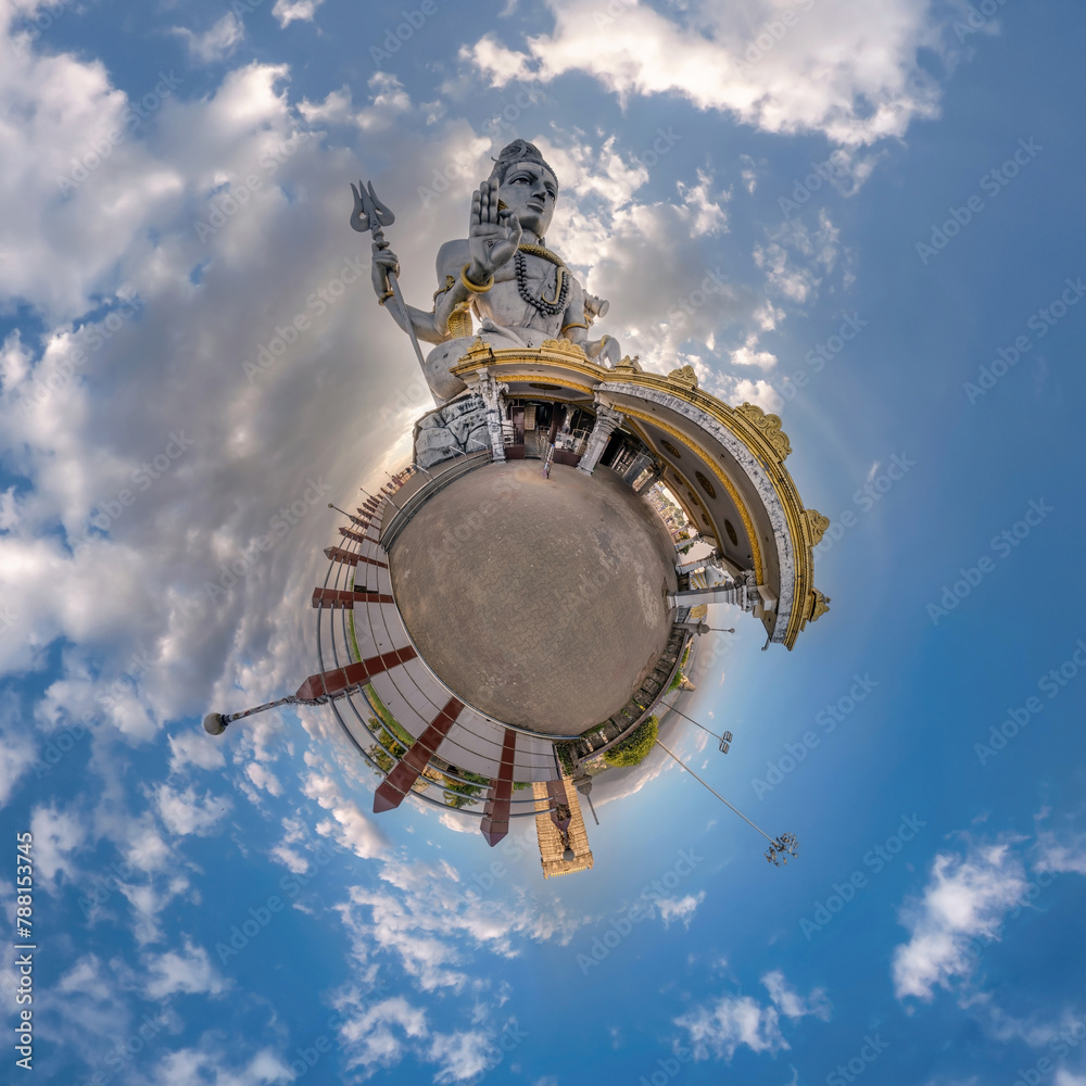 tallest hindu shiva statue in india on mountain near ocean on little planet in blue sky with evening clouds, transformation of spherical 360 panorama. Spherical abstract view with curvature of space.