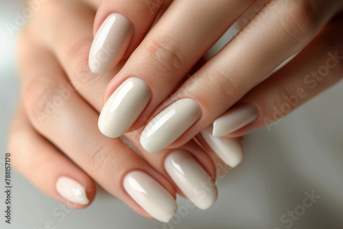 Woman's hands or fingers with natural white pedicure close up, top view
