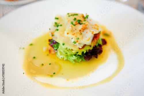 A fresh cod salad artfully arranged atop a variety of crisp lettuces