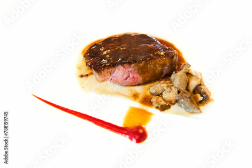 Juicy Sirloin in wine with mushrooms on white background