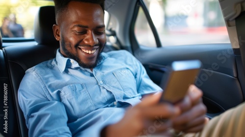 Man Smiling at Smartphone in Car