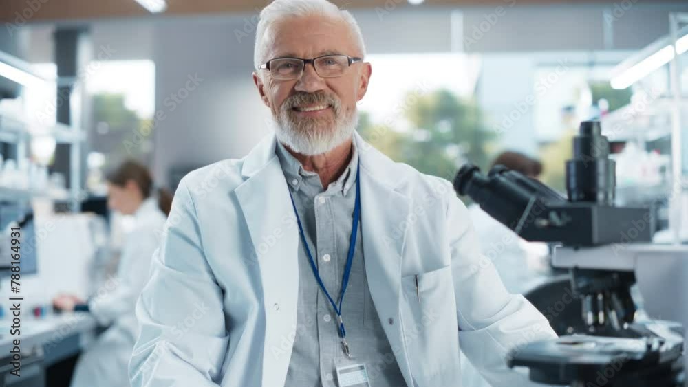 Portrait of a Senior Scientist Posing for Camera, Smiling. Middle Aged Male Biologist in a White Coat Working in a Modern Laboratory, Researching Medical Drug Products and Genome Editing Portrait of a Senior Scientist Posing for Camera, Smiling. Middle Aged Male Biologist in a White Coat Working in a Modern Laboratory, Researching Medical Drug Products and Genome Editing