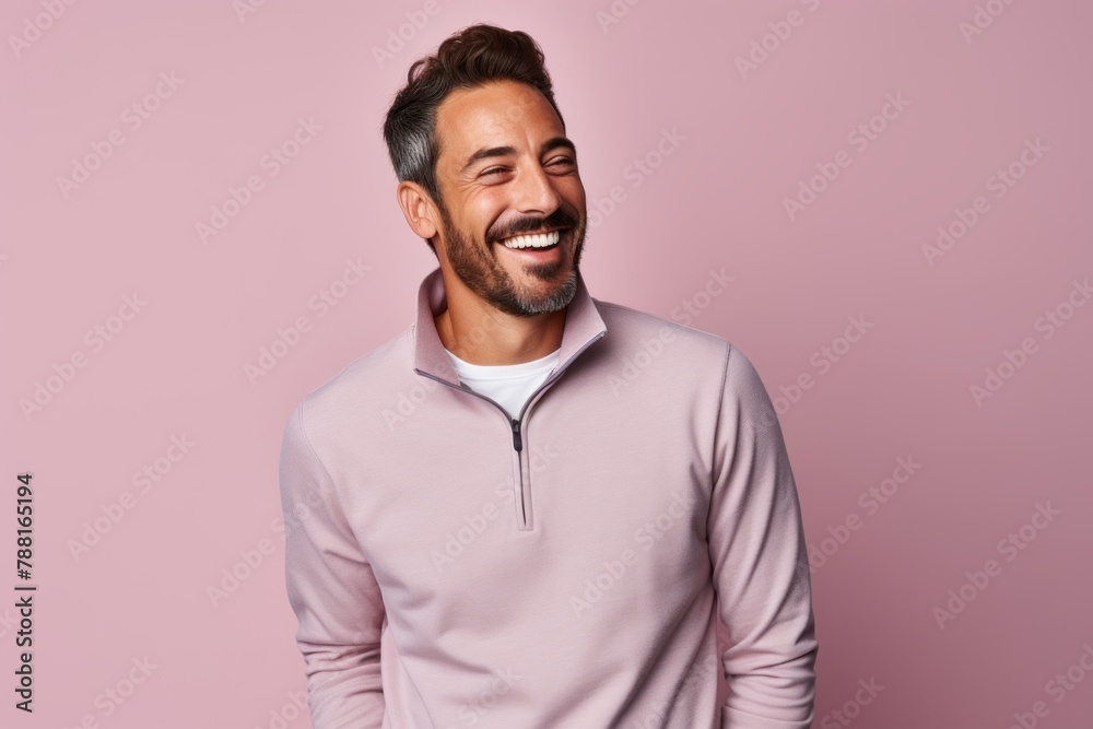 Portrait of a happy man in his 30s wearing a thermal fleece pullover in front of pastel or soft colors background Portrait of a happy man in his 30s wearing a thermal fleece pullover in front of pastel or soft colors background