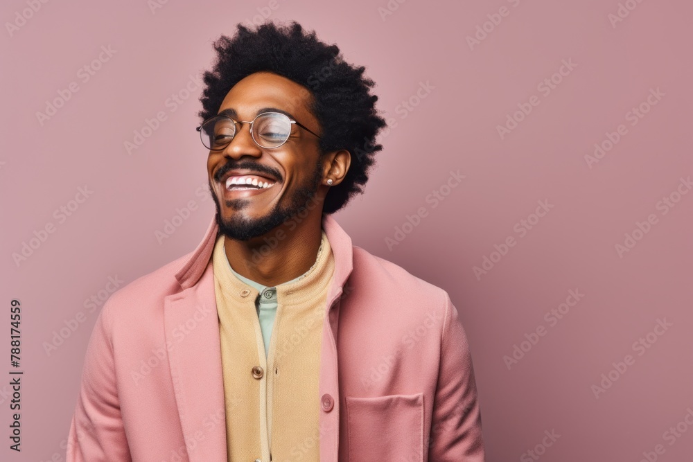 Portrait of a jovial afro-american man in his 20s wearing a chic cardigan while standing against pastel or soft colors background Portrait of a jovial afro-american man in his 20s wearing a chic cardigan while standing against pastel or soft colors background