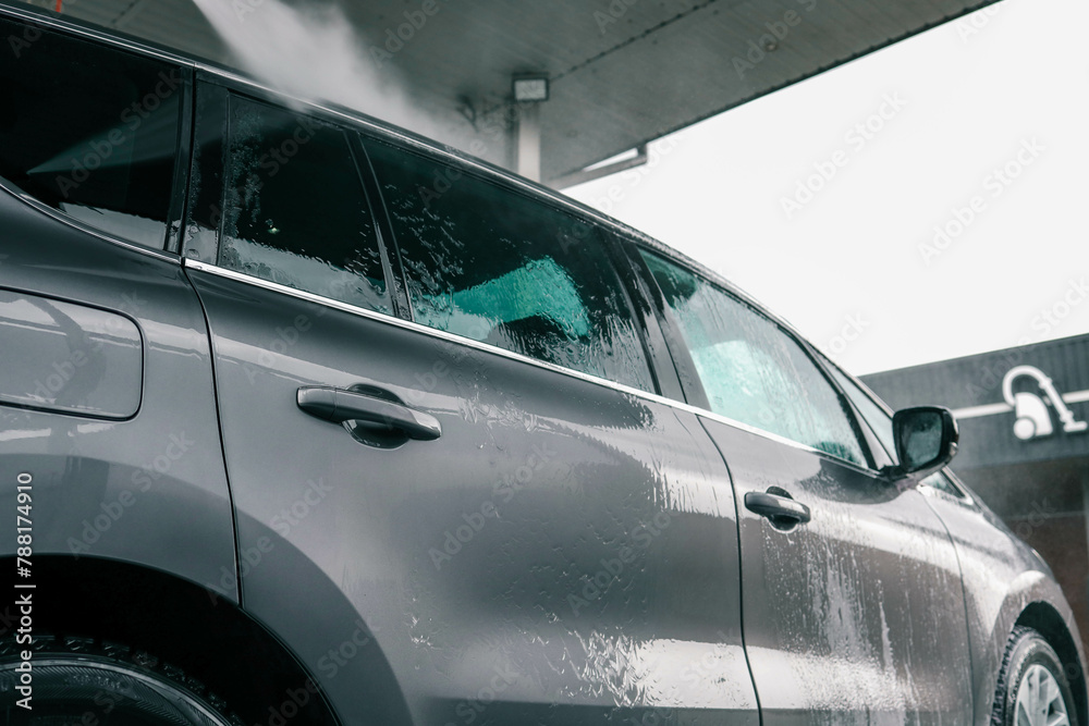 Hand washing car with pink foam, advertising