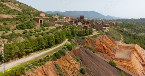 Aerial view of the former Monteponi mine, near Iglesias in Sardinia, Italy. The red color is due to the zinc and lead present in the soil. The mining plant is now closed. Mining concept. photo