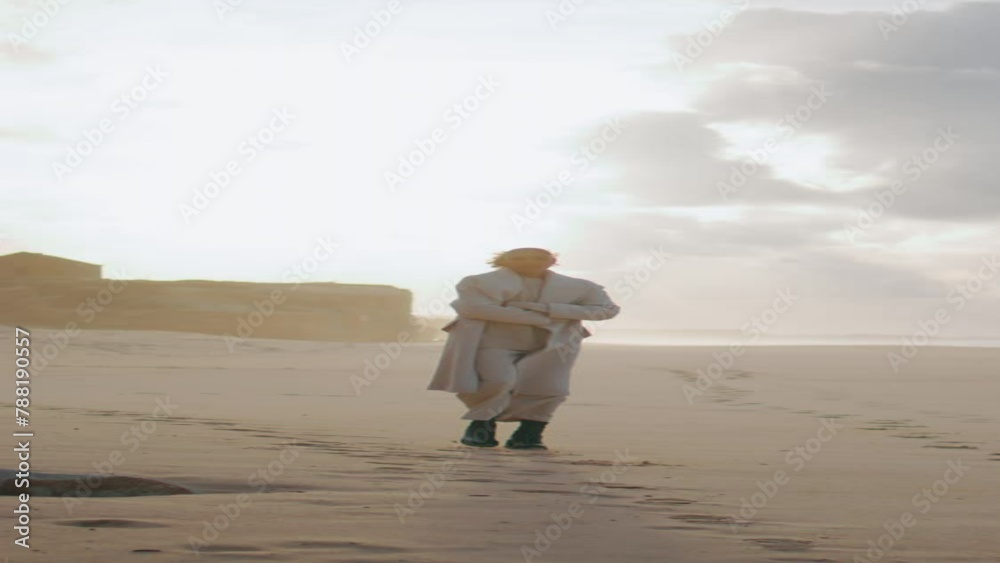 Peaceful model walking sand beach leaving footprints vertical. Travel woman turn