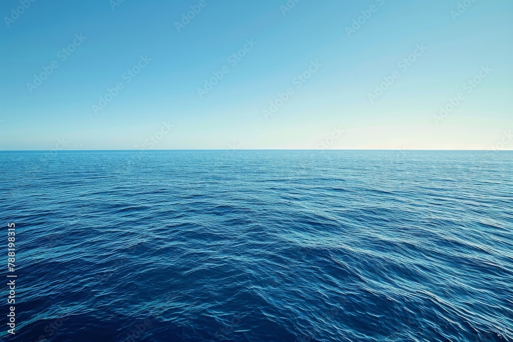 Fototapeta premium A photo featuring a vast body of water with a clear blue sky stretching across the horizon, An endless blue ocean under a clear day sky, AI Generated