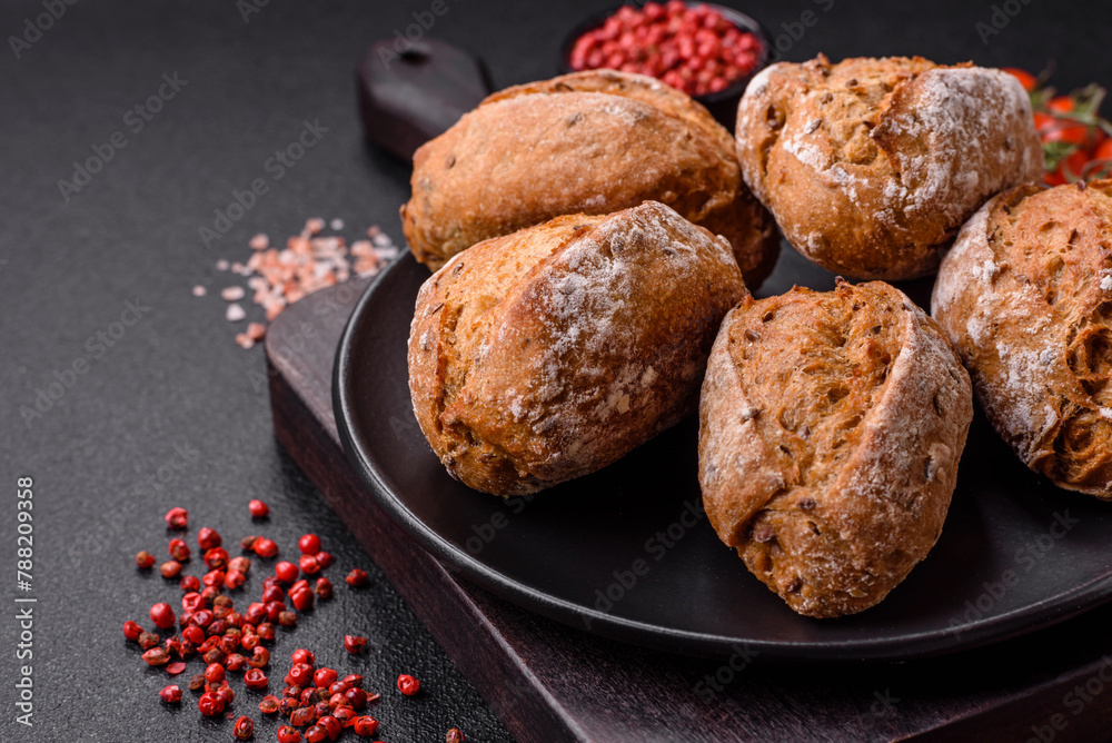 Fototapeta premium Fresh baked bread buns with salt, spices, seeds and grains