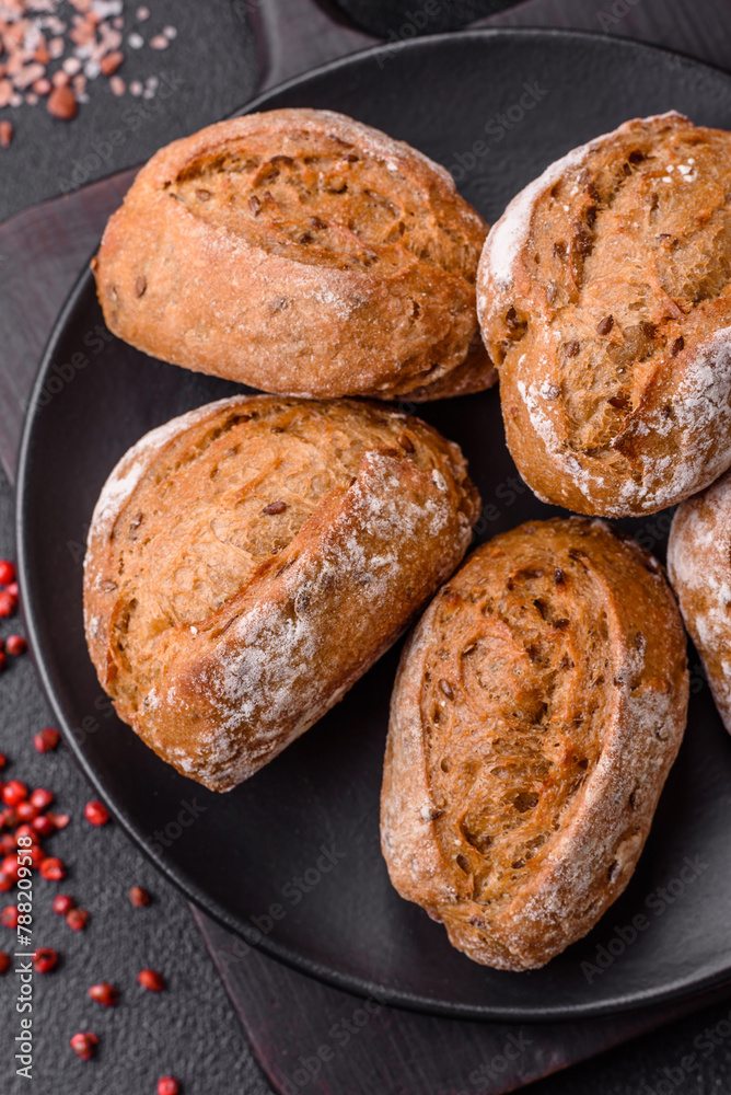Fresh baked bread buns with salt, spices, seeds and grains