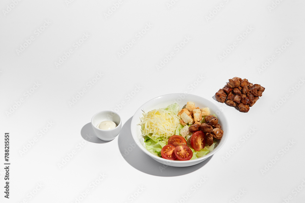 Deconstructed Caesar salad ingredients with neat geometry isolated on white background Deconstructed Caesar salad ingredients with neat geometry isolated on white background