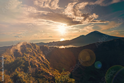 Breathtaking sunrise over Abang mountain, view from Batur volcano and Batur lake, Bali, Indonesia photo