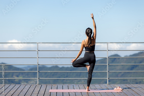 Sport woman do yoga over the mountain © leungchopan