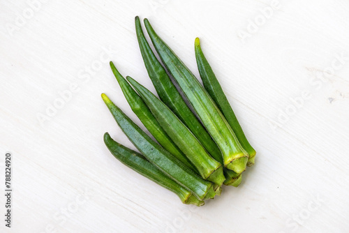 Fresh green vegetable okra or lady's finger isolated on white background. Healthy vegetables for cooking. In the Bengali language, it is called Dherosh.  photo