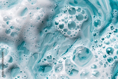 Blue foamy texture in motion top view. Cosmetic facial skin cleanser, shower gel, turquoise foam background. Creamy cleansing skincare product bubbles. Soapy substance. Bubble backdrop. Washing liquid