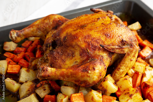 Homemade Hearty Roasted Chicken on a Tray, side view.