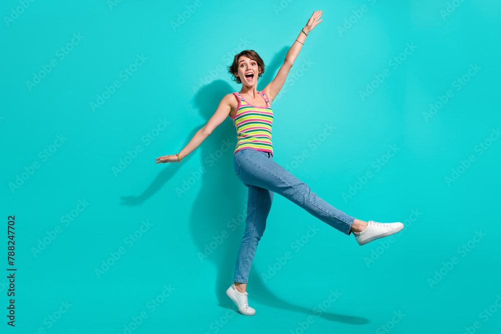 Full body photo of carefree cheerful lady good mood rejoice enjoy dancing isolated on teal color background