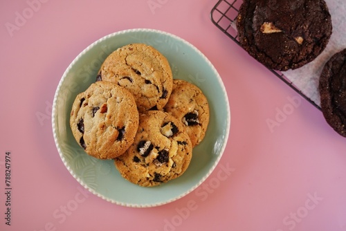 Homemade chewy chocolate chip cookies with glass of milk, selective focus