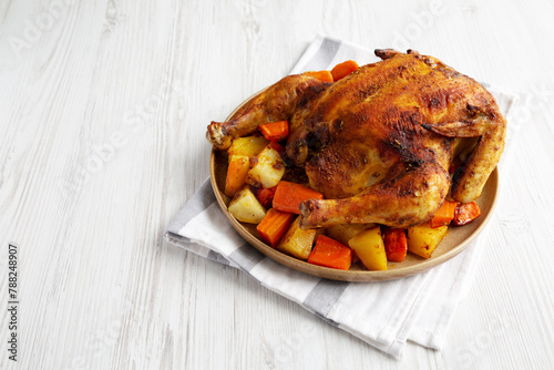 Homemade Hearty Roasted Chicken on a Plate, side view. Space for text. © Liudmyla