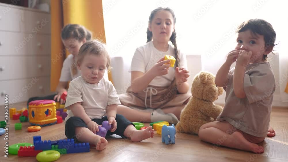  baby group children playing toys on a floor indoors. happy family 
