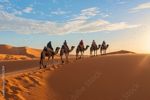 Caravan journey at sunset through sahara desert