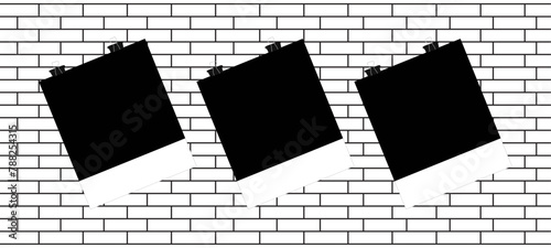 Photo Hanging on a Clerical Clip on a white brick wall background.