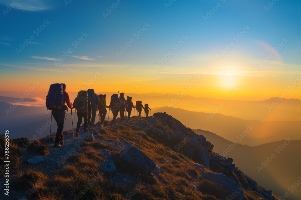 Sunrise trek: group of hikers on mountain trail